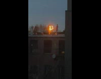 Man Supervises Lady as it Practice Fire Dance