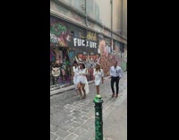 Five people wearing white walk alley video 