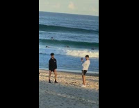 Black sweater shorts guy beach sand sunset