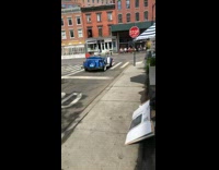 Guy drives vintage blue convertible car 