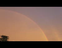 Double rainbow on sunset sky white house