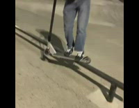 Guy grinds rail with razor scooter, fails and scorpions on concrete floor at skatepark