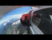 Two girls pink helmets wingsuit sky diving 