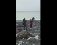 Cream beanie red shirt girl black sand