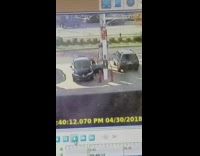 a man in black car breaks door at gas station
