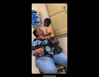 Little boy orange shirt slaps mom in face cheek