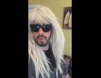 Guy wearing blonde wig shows surfing decor