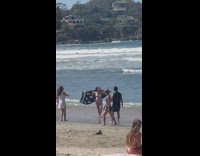 Collab IITW - Lady Holds Up Black Blanket on Beach