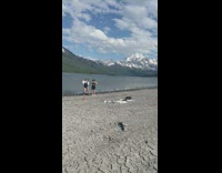 Two women tiktok dance chest bump at the shore