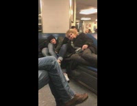 people asleep in line at bus station