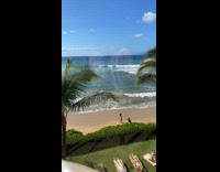 Woman in bikini poses at the beach in time lapse video