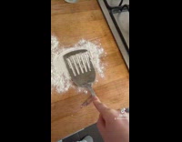 Spatula life hack cuts lines in flour on wood counter