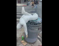 White mannequin art on trashcan 