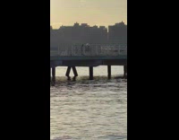 Blonde Woman Dances at Pier in New York 