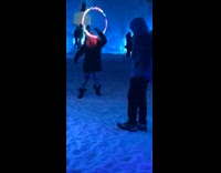 Woman light up hula hoop in snow cave