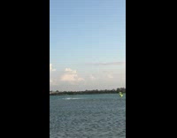 Guy kitesurfing black green parachute ocean fail