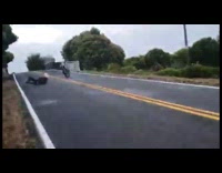 guy on back wheel motorcycle falls off