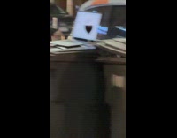 Barefoot man working with laptop on top of trash bin