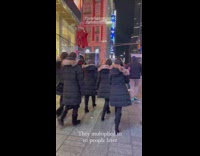 Five people wear same black jacket with fur hood 