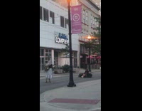 Girl black gown sit move forward pavement