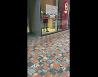 Red shirt guy dances by ATM bank 