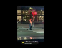 Bald shirtless man dancing in the middle of crosswalk
