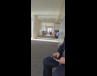 Woman blue sweater selfie glass window hallway