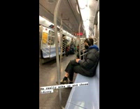 Guy wears face mask on forehead subway 