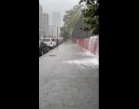 Water falls from court fence to sidewalk