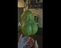 Shrek ogre shaped green fruit on holder