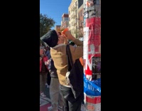 Man blows conch shell at the marathon