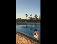 Man long hair flip swimming pool sunset