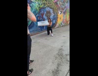 Girl kneel wall graffiti big pizza box
