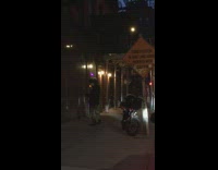 Guy swings two purple LED balls motorcycle 