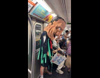 Person wearing andrew cuomo costume with scum sign