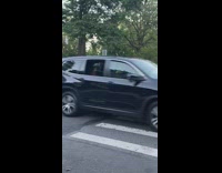 2 Ladies cross street with pizza outfits 