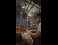 Woman dance inside bar phone on shelves