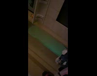 Person in blue glowing costume walking through hallway