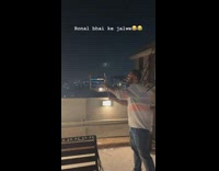 Guy lights firework lands next to him