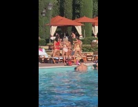 Four ladies kneel pose on pool chairs 