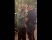 Collab WINY - Man with tinfoil headdress talks to cop 