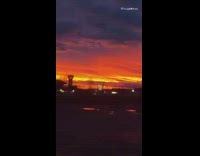 Sunrise red sky gas station grey cloud