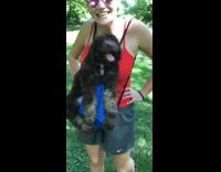 Girl carries brown puppy blue drawstring backpack