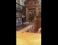 woman poses while reading book at entrance