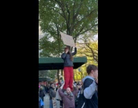 Woman hold sign about weed on marathon