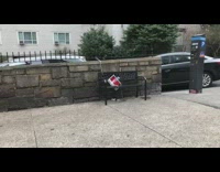 Public park bench has private property sign taped on it