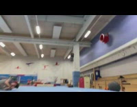 Guy does flips on gymnastics tumbling mat, falls, and lands on shoulder