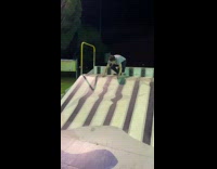 Guy on stomach slides down skateboard ramp 