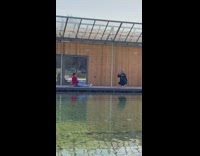 Woman red shirt sit beside water pond