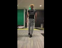 Guy does bicep curls at the gym, then starts dancing when asked if he works out